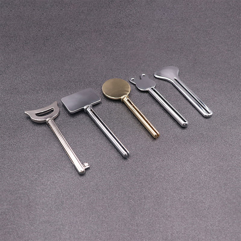 Kovový dávkovač zubní pasty Čisticí prostředek na obličej Lis na tuby na zuby Key Shape Kosmetika na tuby